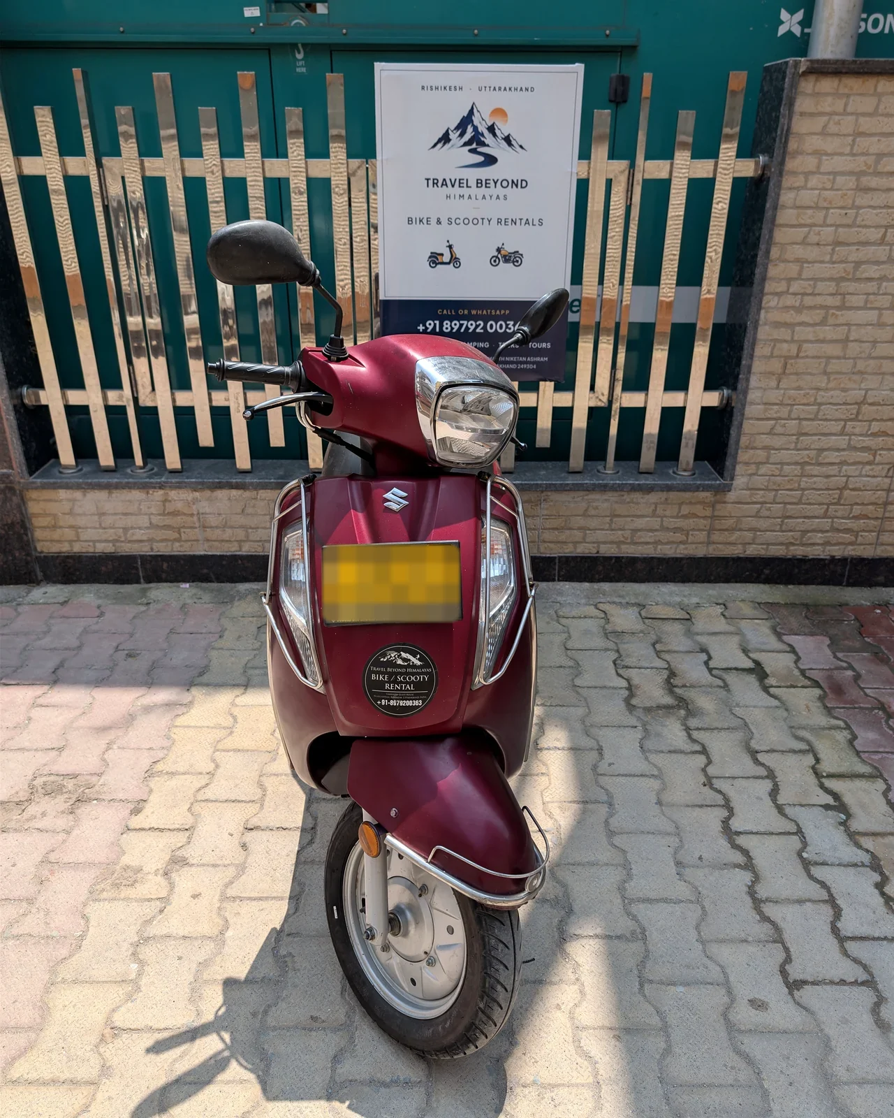 Front view of a red Travel Beyond Himalayas rental scooter in Rishikesh