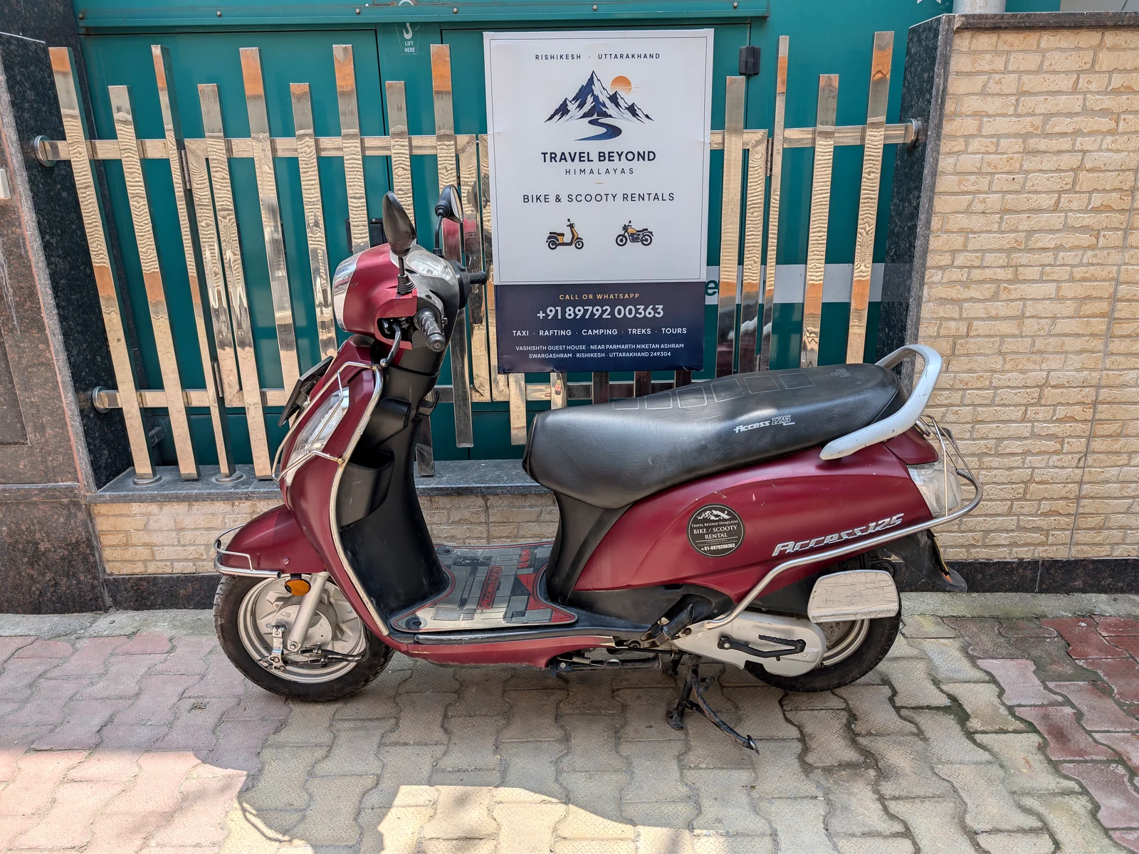 Red petrol scooter available for rent from Travel Beyond Himalayas in Rishikesh
