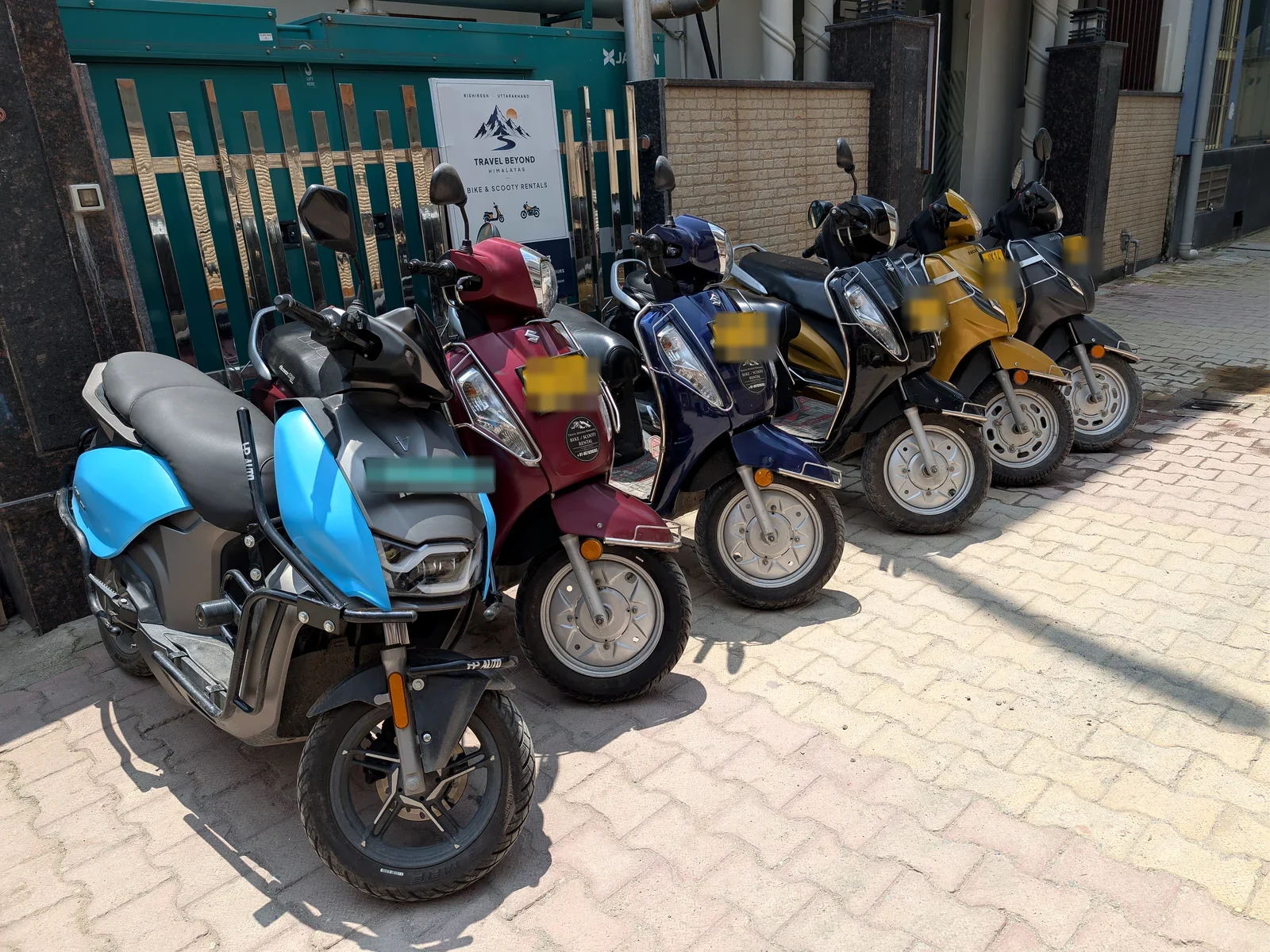 The Travel Beyond Himalayas scooter fleet lined up outside the office in Swarg Ashram, Rishikesh