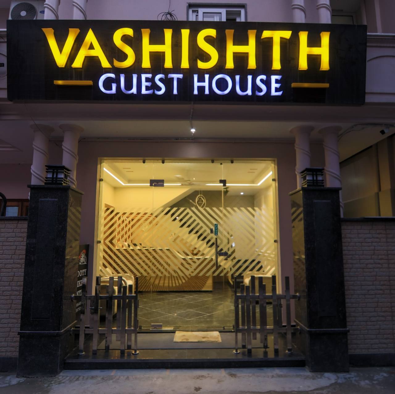 Illuminated Vashishth Guest House entrance at night where the Travel Beyond Himalayas office is located